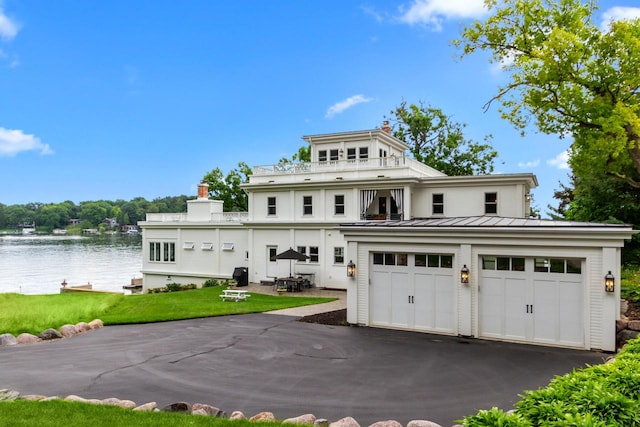 view of front of home with a garage and a front lawn