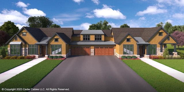 view of front of home featuring a garage and a front lawn