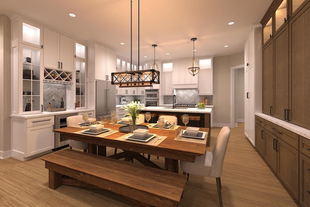 dining area with light wood-type flooring and sink