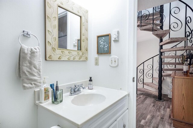 bathroom with hardwood / wood-style flooring and vanity