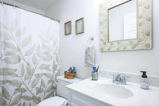 bathroom with toilet and vanity