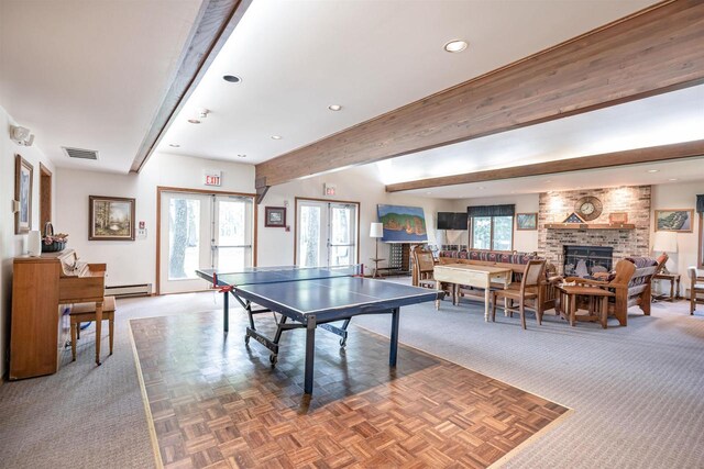 playroom featuring a fireplace, parquet floors, beamed ceiling, and french doors