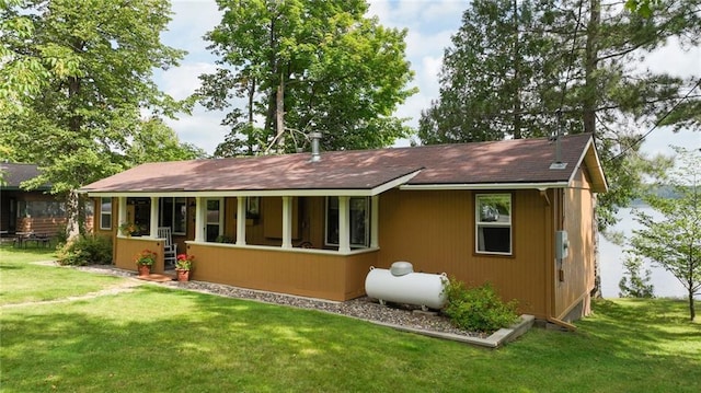 rear view of property with a yard