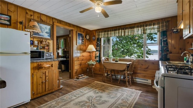 12810 N County Highway T, Hayward, WI 54843 - kitchen with white appliances, sink, dark wood-type flooring, and wooden walls