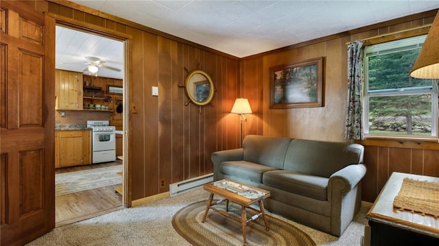 12810 N County Highway T, Hayward, WI 54843 - living room featuring light colored carpet, a baseboard heating unit, and wooden walls