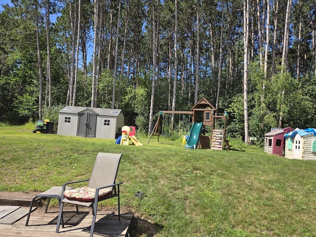 view of yard featuring a storage unit and a playground