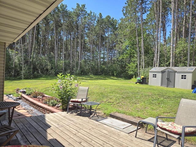 wooden terrace featuring a storage unit and a yard