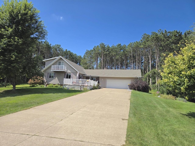 view of front of property with a front yard and a garage