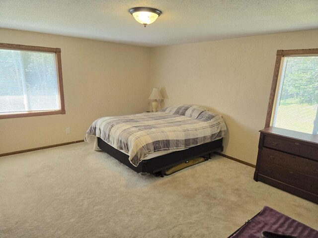 bedroom with ceiling fan and light carpet