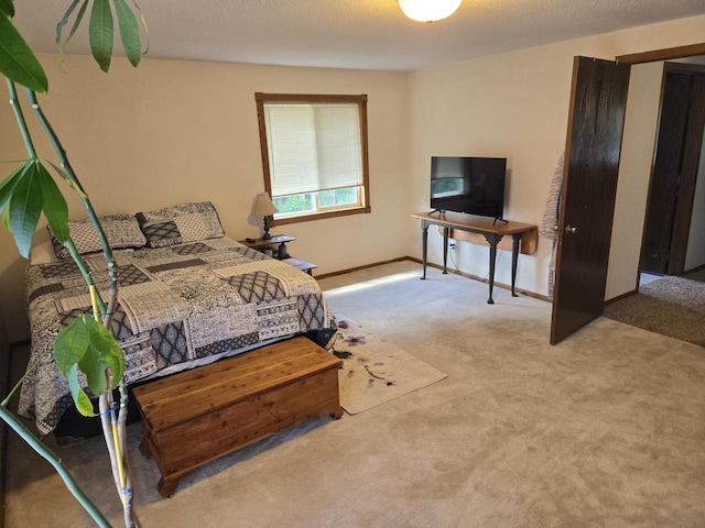 bedroom featuring light colored carpet and a textured ceiling