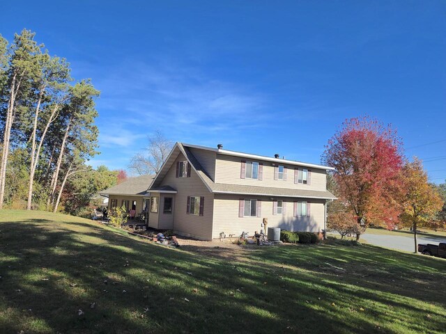 rear view of house with a lawn