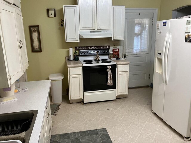 kitchen with white refrigerator with ice dispenser, sink, range with electric cooktop, and white cabinets