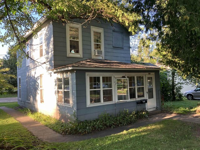 view of side of home featuring a lawn