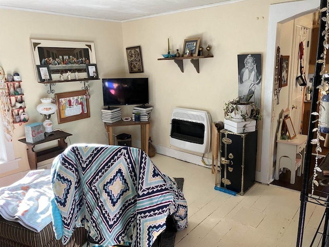 living room with heating unit and ornamental molding