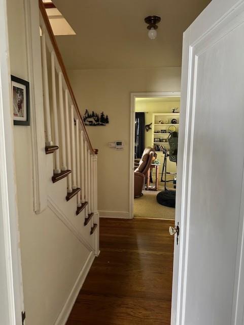 corridor featuring dark hardwood / wood-style flooring