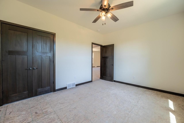 unfurnished bedroom with ceiling fan, a closet, and light tile patterned floors