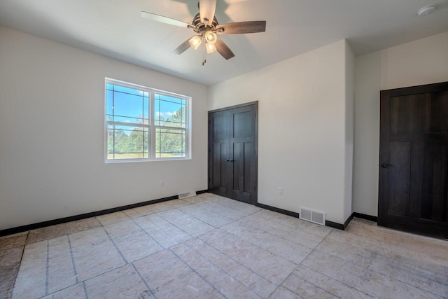 unfurnished bedroom featuring ceiling fan and light tile patterned floors