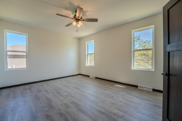 spare room featuring ceiling fan and light hardwood / wood-style flooring