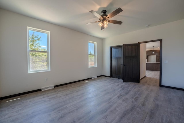 unfurnished bedroom featuring ceiling fan and hardwood / wood-style flooring