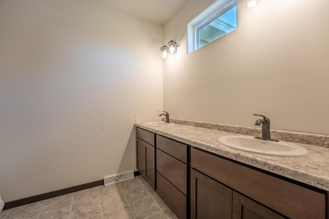 bathroom with tile patterned floors and vanity