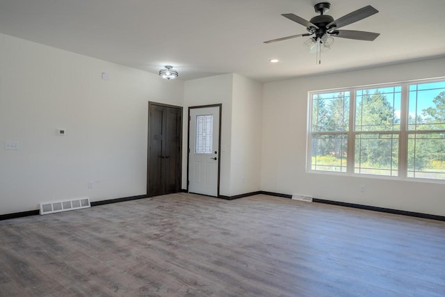 empty room with ceiling fan and hardwood / wood-style floors