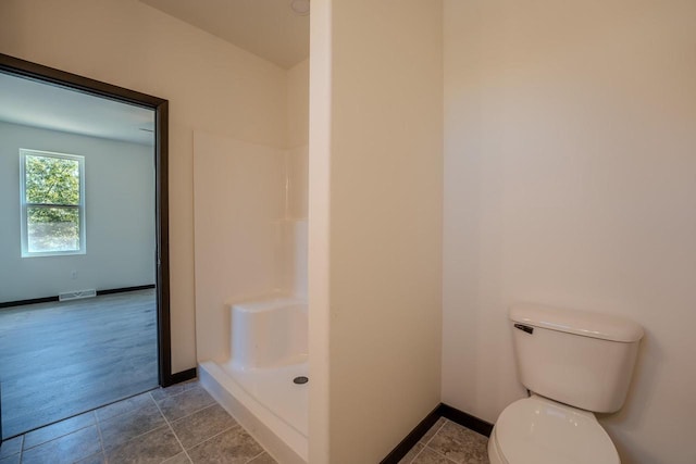 bathroom with a shower, wood-type flooring, and toilet