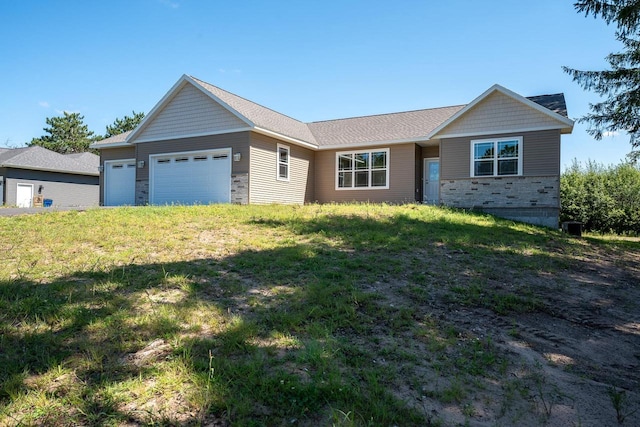 ranch-style house featuring a garage and a front yard