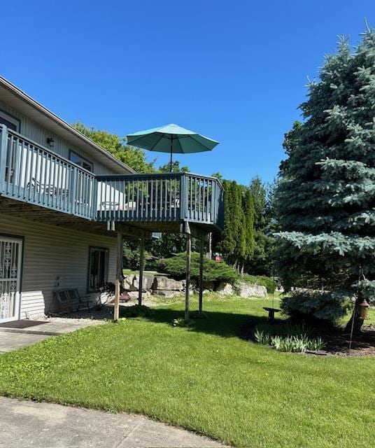 view of yard with a wooden deck and a patio area