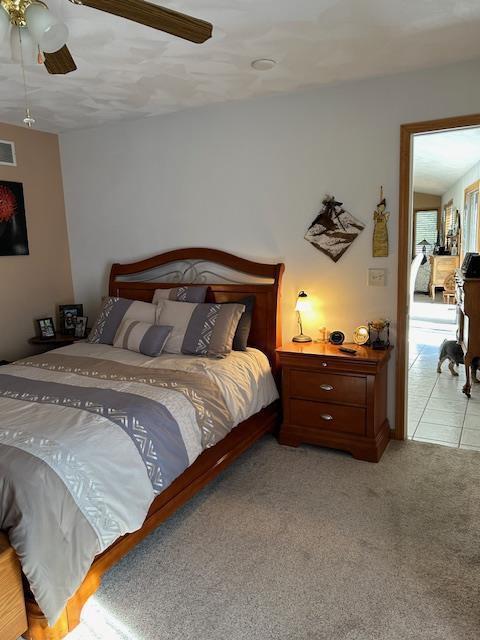 carpeted bedroom featuring ceiling fan