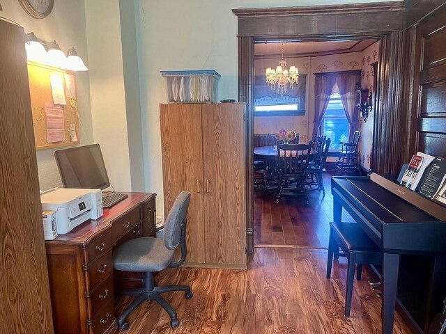 office space with dark wood-type flooring and a notable chandelier