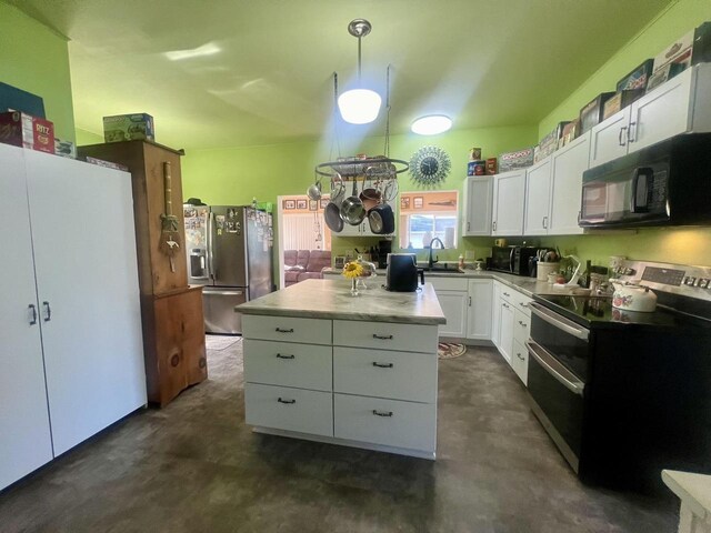 kitchen with white cabinetry, hanging light fixtures, stainless steel appliances, a kitchen island, and sink