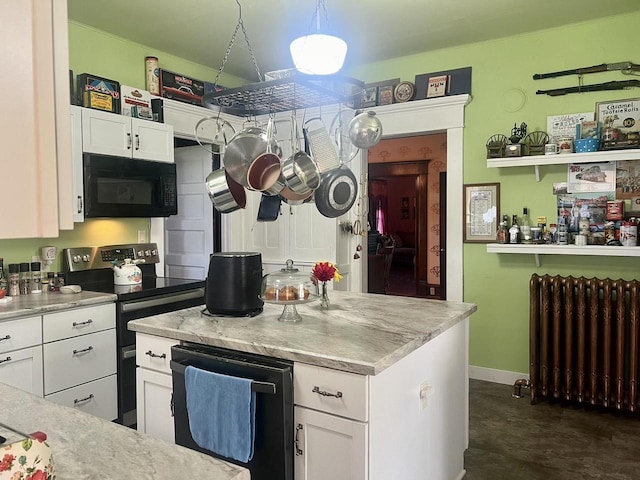 kitchen with radiator heating unit, white cabinetry, black appliances, and decorative light fixtures