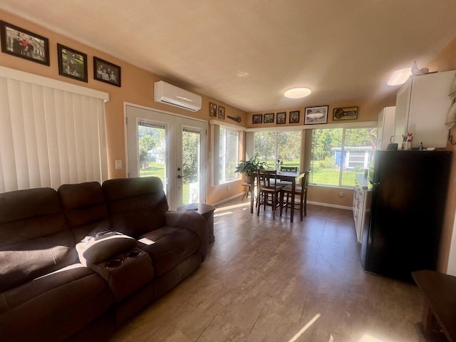 living room with a wall unit AC and french doors