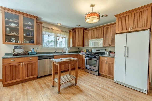 kitchen with sink, light hardwood / wood-style floors, and stainless steel appliances