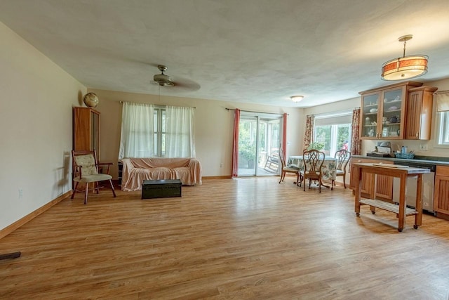 living area featuring ceiling fan and light hardwood / wood-style flooring