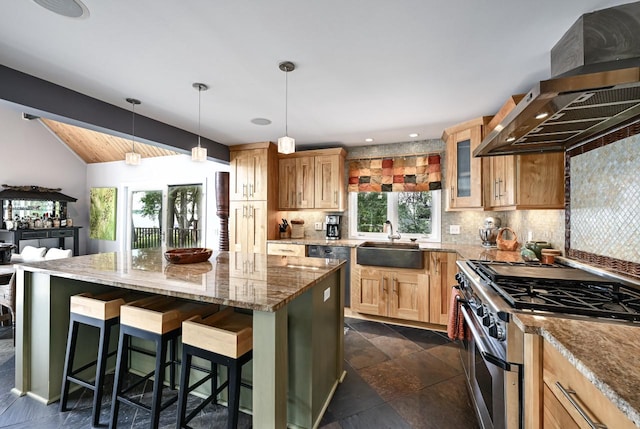 kitchen with high end stainless steel range, decorative backsplash, wall chimney exhaust hood, sink, and a center island