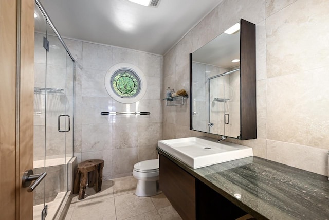 bathroom featuring tile walls, vanity, walk in shower, and toilet