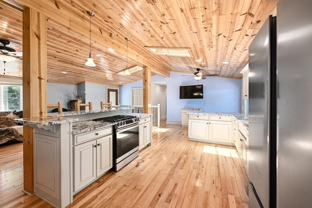 kitchen with ceiling fan, appliances with stainless steel finishes, pendant lighting, and wood ceiling