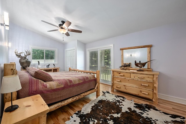 bedroom featuring hardwood / wood-style flooring, a closet, access to outside, ceiling fan, and lofted ceiling