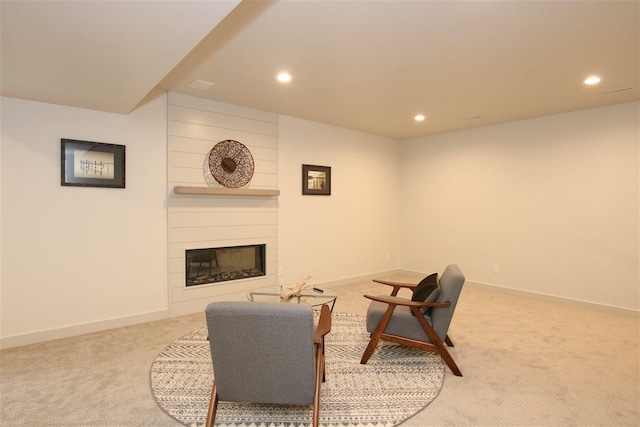 living room with carpet flooring, a large fireplace, and baseboards