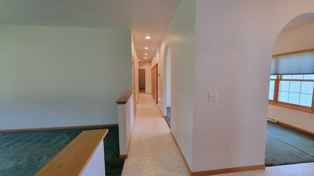 corridor with light colored carpet