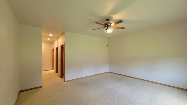 carpeted spare room with ceiling fan