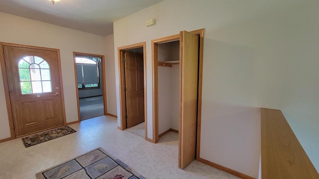 entryway with light colored carpet