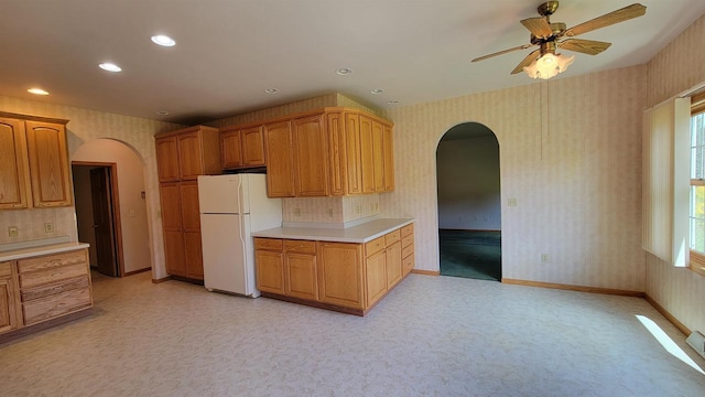 kitchen featuring ceiling fan, tasteful backsplash, white fridge, and light carpet