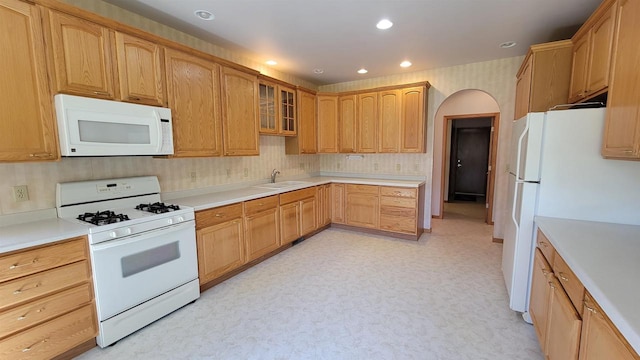 kitchen with sink and white appliances