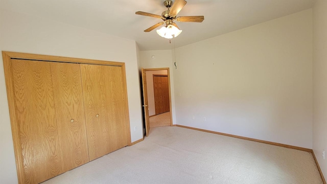 unfurnished bedroom featuring a closet, ceiling fan, and light colored carpet