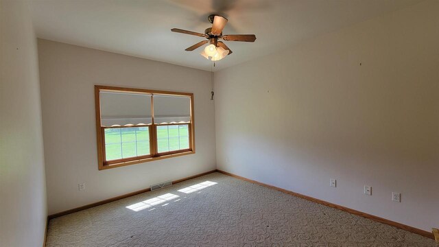 empty room with light colored carpet and ceiling fan