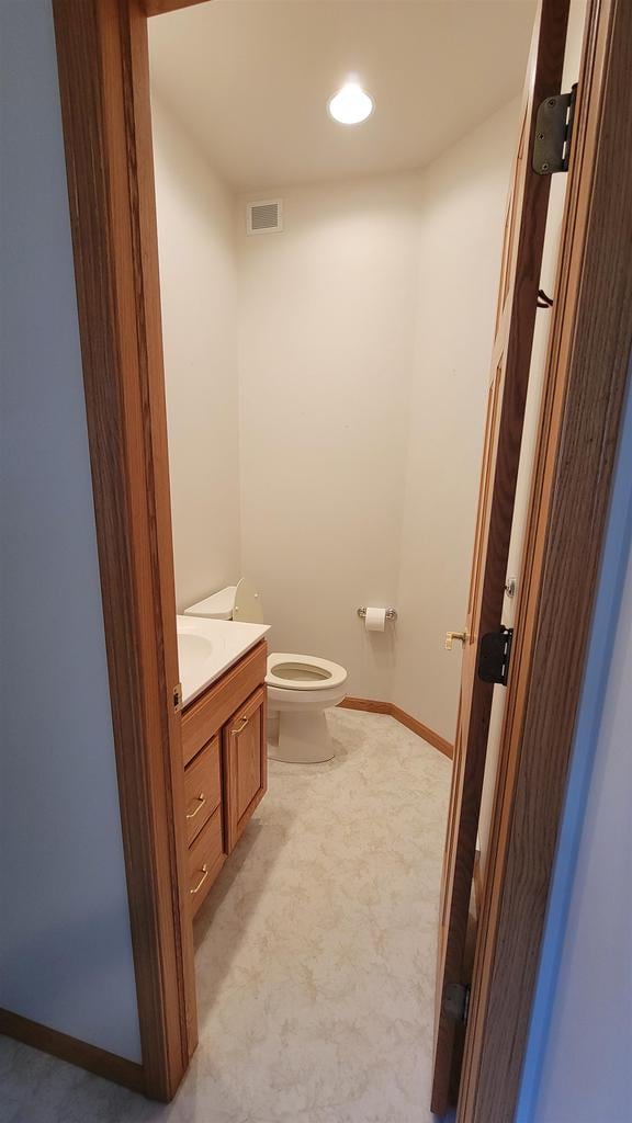 bathroom featuring vanity and toilet