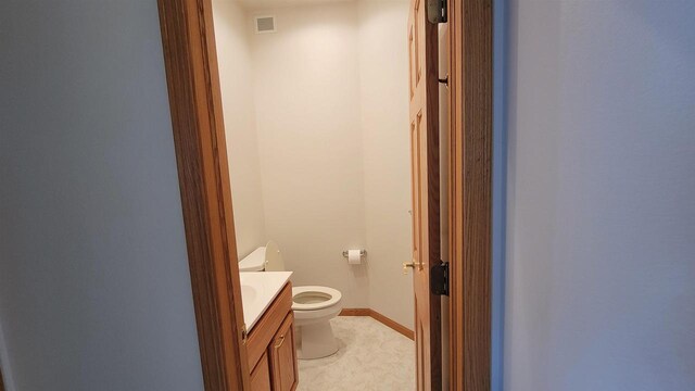 bathroom featuring toilet and vanity