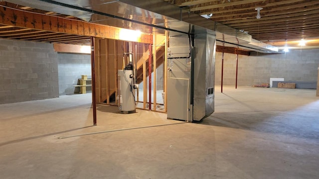 basement featuring water heater and heating unit